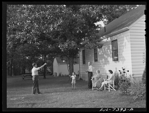 Cass Lake, near Pontiac, Michigan. Eric Westerberg, his young son Karl, his father and mother, Mr. and Mrs. Karl Westerberg, and Mrs. Eric Westerberg in the backyard of their home. Mr. Westerberg and his son Eric built this home themselves in their spare time. It is a modern well-designed home with 