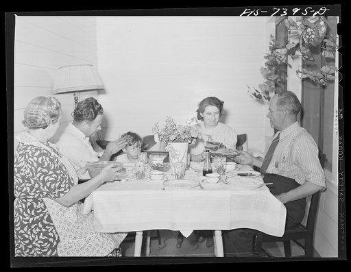 Cass Lake, near Pontiac, Michigan. Evening meal in the Westerberg home. Left to right, Mrs. Karl Westerberg, Eric and his son, Karl; Mrs. Eric Westerberg, and Karl Axel Westerberg. The tradition of the Swedish hospitality is observed in America, and the family meal is always enjoyable in the Westerb