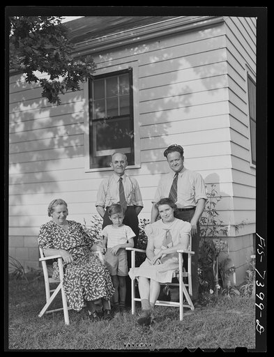 Cass Lake, near Pontiac, Michigan. The Westerberg family outside the home which Karl and his son, Eric, built themselves after working hours. Karl Axel Westerberg and his son Eric stand in back of Mrs. Karl Axel Westerberg, Eric's son Karl, and his wife