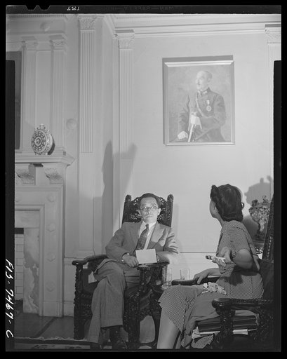 Washington, D.C. International student assembly. Dr. Hu Shih, Chinese ambassador, talking with Miss Shih-Yung Wang in the reception room of the Chinese embassy