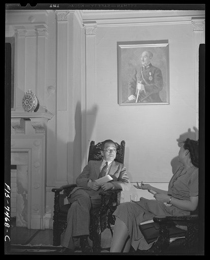 Untitled photo, possibly related to: Washington, D.C. International student assembly. Dr. Hu Shih, Chinese ambassador, talking with Miss Shih-Yung Wang in the reception room of the Chinese embassy