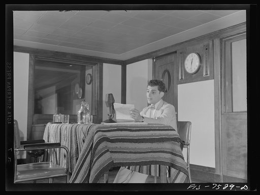 Untitled photo, possibly related to: Washington, D.C. Lucky Baum, who spoke in French at the international student assembly, reading a short talk at the Department of Interior radio studios. Lucky said he had worked for a French newspaper as a photographer