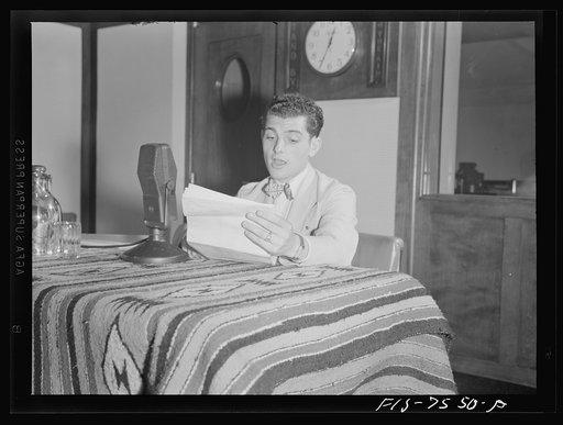 Washington, D.C. Lucky Baum, who spoke in French at the international student assembly, reading a short talk at the Deptartment of Interior radio studios. Lucky said he had worked for a French newspaper as a photographer