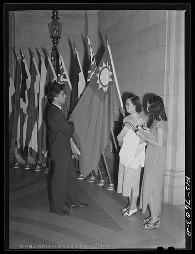 Washington, D.C. International youth assembly. An American student discussing the Chinese flag with two Chinese delegates