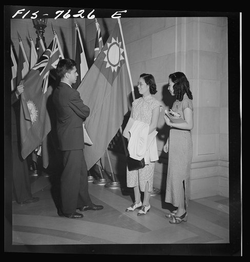 Untitled photo, possibly related to: Washington, D.C. International youth assembly. An American student discussing the Chinese flag with two Chinese delegates