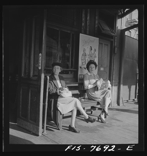 New York, New York. Women waiting for an elevated train at 67th Street and Third Avenue station, 8:30 a.m.