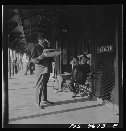 New York, New York. Waiting for the Third Avenue elevated train in the "Fifties" at 8:30 a.m.