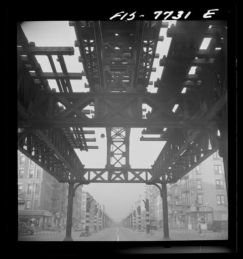 New York, New York. Looking south at 7 a.m. from 13th Street on Second Avenue, showing the elevated railway in midst of demolition