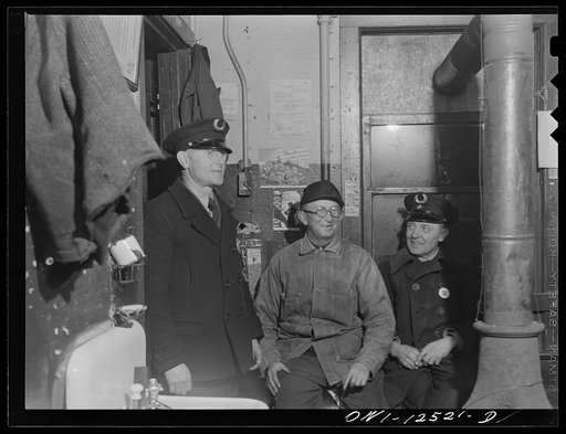 Untitled photo, possibly related to: Chicago, Illinois. Workmen in the hump office resting a few minutes while waiting for the next "cut" to come over the hump in a Chicago and Northwestern Railroad yard