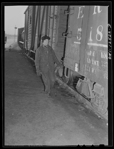 Chicago, Illinois. Hump helper uncoupling cars as they come over the hump at a Chicago and Northwestern Railroad yard