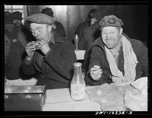 Chicago, Illinois. Workman employed at the repair tracks of a Chicago and Northwestern Railroad yard having lunch