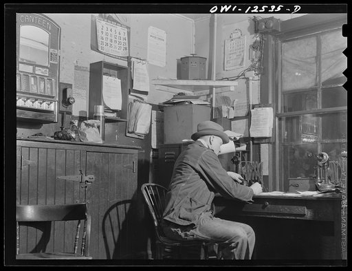 Chicago, Illinois. Train clerk working on his lists in the hump office at a Chicago and Northwestern Railroad yard