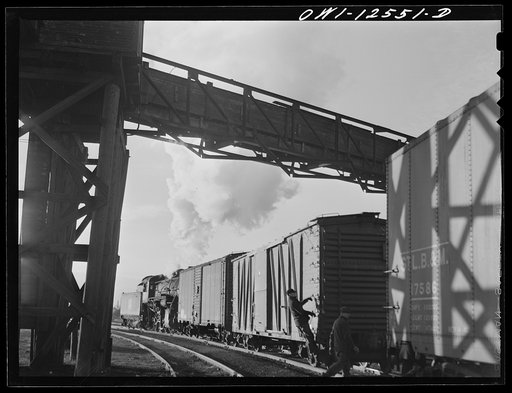 Chicago, Illinois. Switchman riding a car in a flat switching yard of the Chicago and Northwestern Railroad