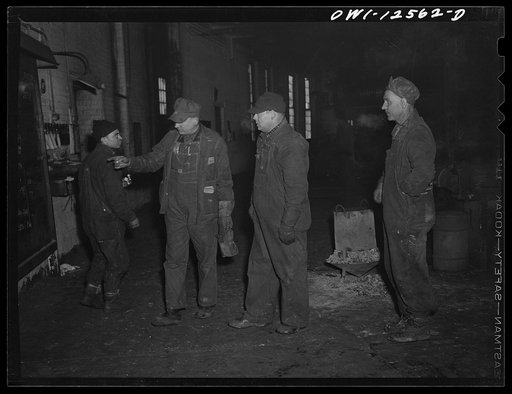 Chicago, Illinois. Workers studying the work schedule bulletin board at the roundhouse at a yard of the Chicago and Northwestern Railroad