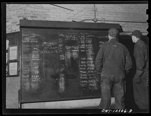 Untitled photo, possibly related to: Chicago, Illinois. Workers studying the work schedule bulletin board at the roundhouse at a yard of the Chicago and Northwestern Railroad