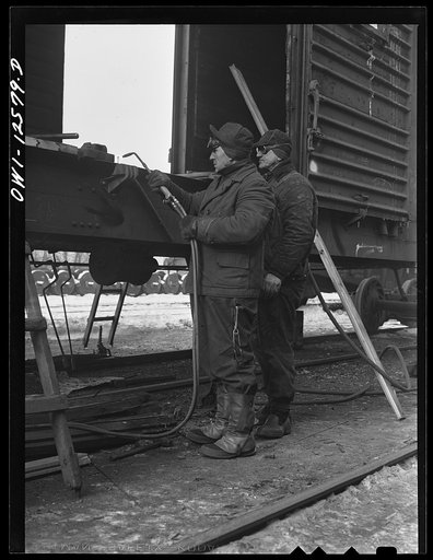 Chicago, Illinois. Workmen repairing a freight car on the "rip" tracks at a yard of the Chicago and Northwestern Railroad