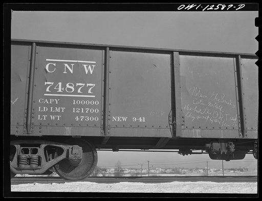 Chicago, Illinois. A car going over the hump tracks at a yard of the Chicago and Northwestern Railroad. Beyond is a new village that has sprung up since the building of a war plant in the vicinity