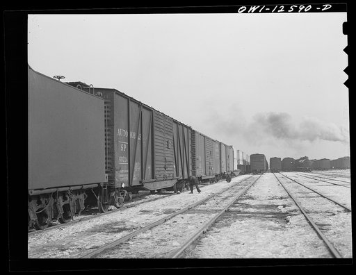 Chicago, Illinois. Car inspectors at work in one of the yards of the Chicago and Northwestern Railroad