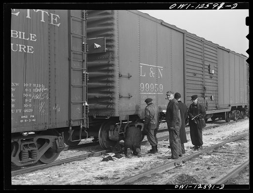 Chicago, Illinois. Making running repairs of a faulty brake shoe which car inspectors have found at a yard of the Chicago and Northwestern Railroad