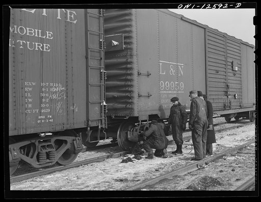 Untitled photo, possibly related to: Chicago, Illinois. Making running repairs of a faulty brake shoe which car inspectors have found at a yard of the Chicago and Northwestern Railroad