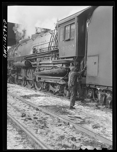 Chicago, Illinois. Engineer getting into his cab. In a few minutes this train will leave a Chicago and Northwestern Railroad yard for the west coast