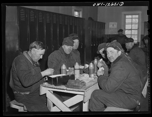 Chicago, Illinois. Workmen employed by the Chicago and Northwestern Railroad at the repair tracks having lunch