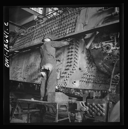 Untitled photo, possibly related to: Chicago, Illinois. In the Chicago and Northwestern locomotive repair shop