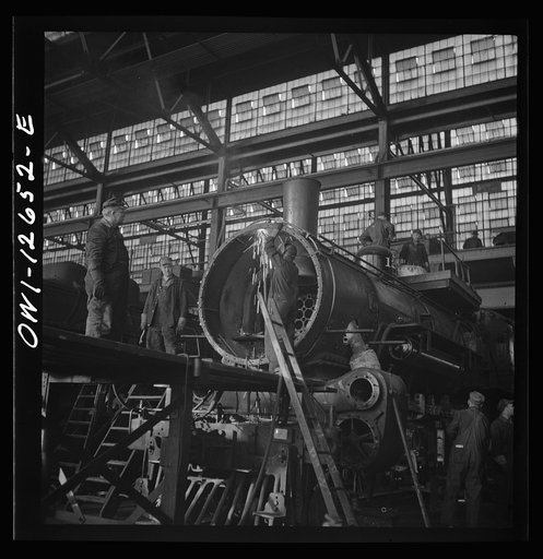 Untitled photo, possibly related to: Chicago, Illinois. Working on a locomotive at the Chicago and Northwestern Railroad shops