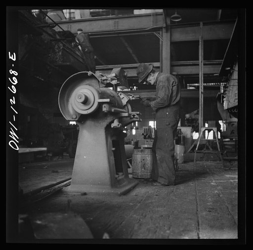 Chicago, Illinois. Workman grinding out a small part at the Chicago and Northwestern Railroad repair shops