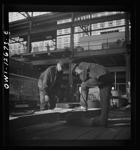 Untitled photo, possibly related to: Chicago, Illinois. Workmen studying blueprints in the Chicago and Northwestern Railroad repair shops