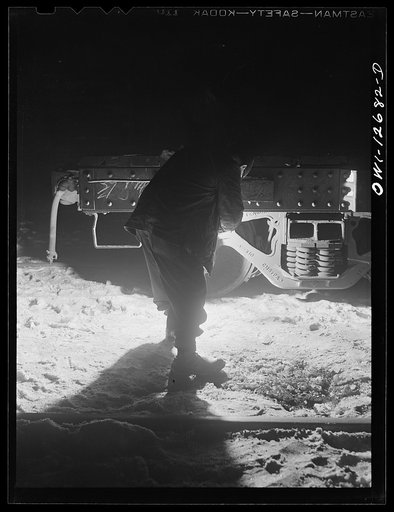 Chicago, Illinois. Inspecting journal boxes at night at a Chicago and Northwestern Railroad yard