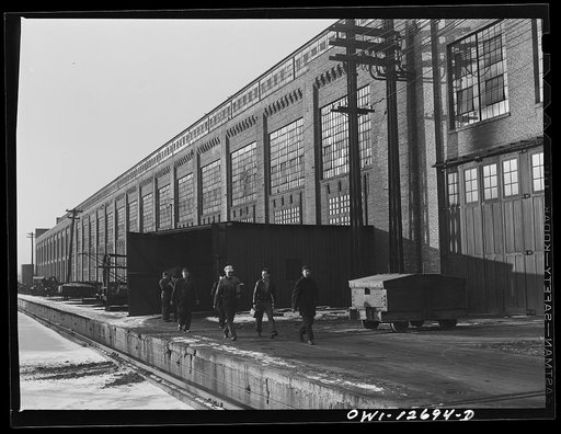 Chicago, Illinois. Workmen coming out of the Chicago and Northwestern Railroad locomotive shops at the end of the shift