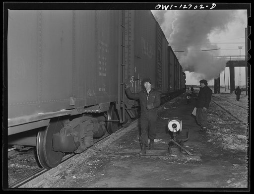 Chicago, Illinois. Switchmen making up a train at a Chicago and Northwestern Railroad