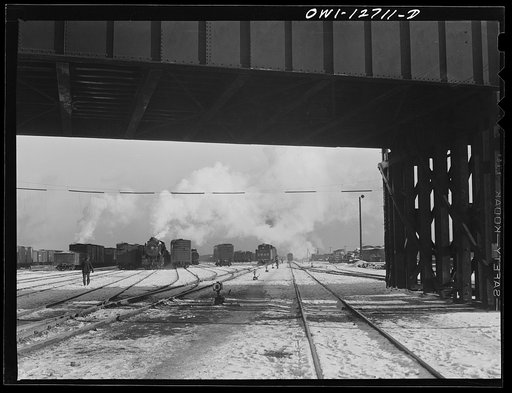 Untitled photo, possibly related to: Chicago, Illinois. Gondola cars loaded with war equipment in one of the Chicago and Northwestern classification yards