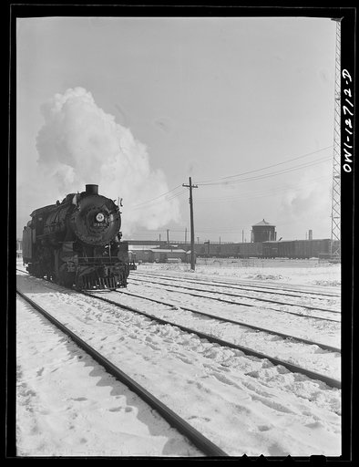 Untitled photo, possibly related to: Chicago, Illinois, Engine taking on water at a Chicago and Northwestern Railroad yard