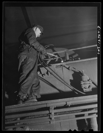Chicago, Illinois. Welder working on an engine at the Chicago and Northwestern Railroad locomotive shops