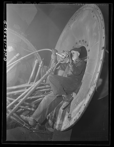 Chicago, Illinois. Working on the pipes that go into the boiler of a locomotive at the Chicago and Northwestern Railroad roundhouse