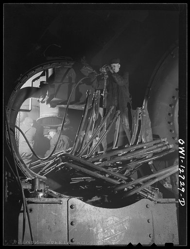 Chicago, Illinois. Working on the pipes that go into the boiler of a locomotive at the Chicago and Northwestern Railroad roundhouse