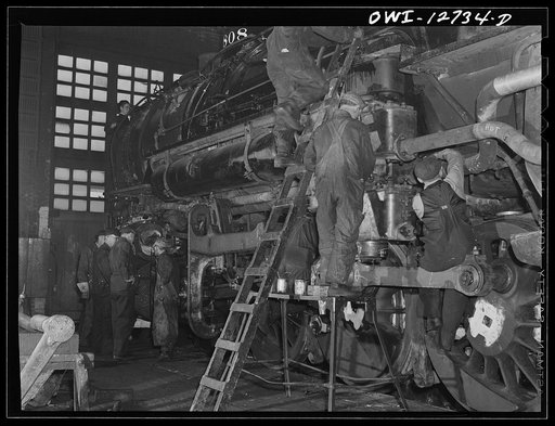 Untitled photo, possibly related to: Chicago, Illinois. Working on a locomotive at the Chicago and Northwestern Railroad locomotive repair shops