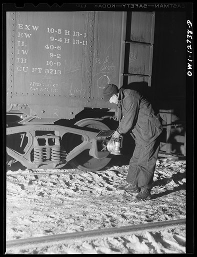 Chicago, Illinois. Inspecting journal boxes at night at a Chicago and Northwestern Railroad yard