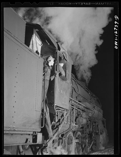 Chicago, Illinois. Engineer and fireman on the Chicago and Northwestern Railroad waiting for the highball sign before pulling out of the yard for Clinton, Iowa