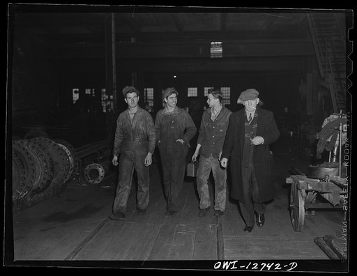 Chicago, Illinois. Men leaving work at the Chicago and Northwestern Railroad shops at the end of a shift