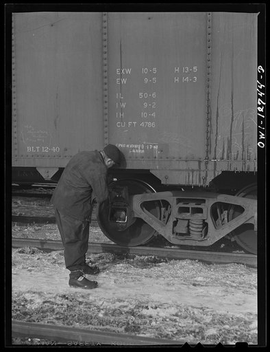 Chicago, Illinois. Inspecting journal boxes at a Chicago and Northwestern Railroad yard