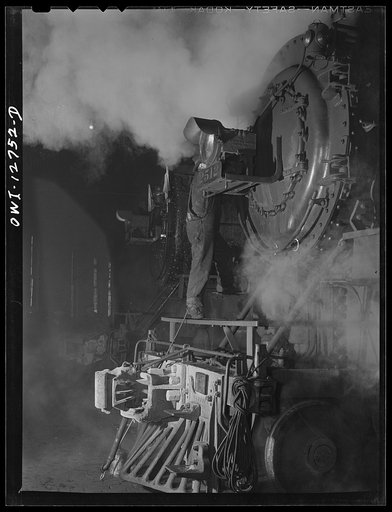 Untitled photo, possibly related to: Chicago, Illinois. Servicing an engine at the roundhouse at a Chicago and Northwestern Railroad yard
