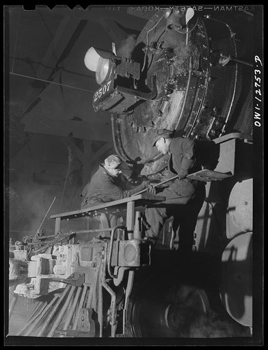 Chicago, Illinois. Servicing an engine at the roundhouse at a Chicago and Northwestern Railroad yard