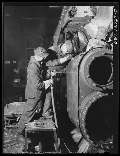 Chicago, Illinois. Working on the cylinders of a locomotive at the Chicago and Northwestern repair shops