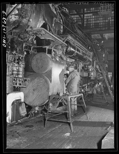 Chicago, Illinois. Working on the cylinders of a locomotive at the Chicago and Northwestern Railroad repair shops
