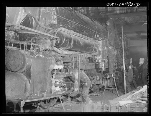 Untitled photo, possibly related to: Chicago, Illinois. Working on the cylinders of a locomotive at the Chicago and Northwestern Railroad repair shops