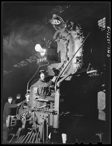 Untitled photo, possibly related to: Chicago, Illinois. Servicing an engine at the roundhouse at a Chicago and Northwestern Railroad yard