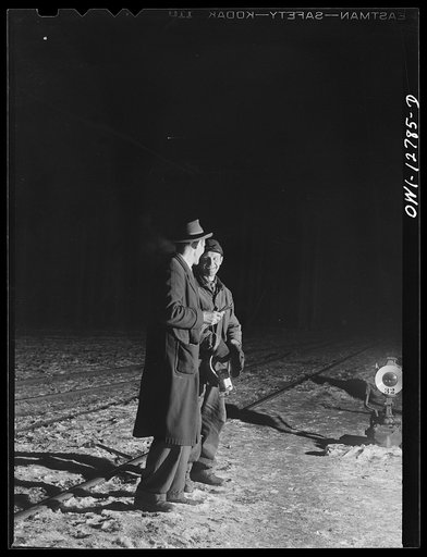 Chicago, Illinois. Switchman and train clerk during a lull in the switching in one of the Chicago and Northwestern Railroad classification yards